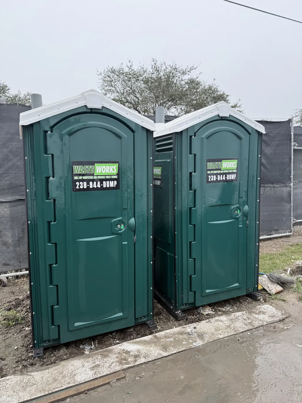 Two branded Waste Works portable toilets positioned side by side