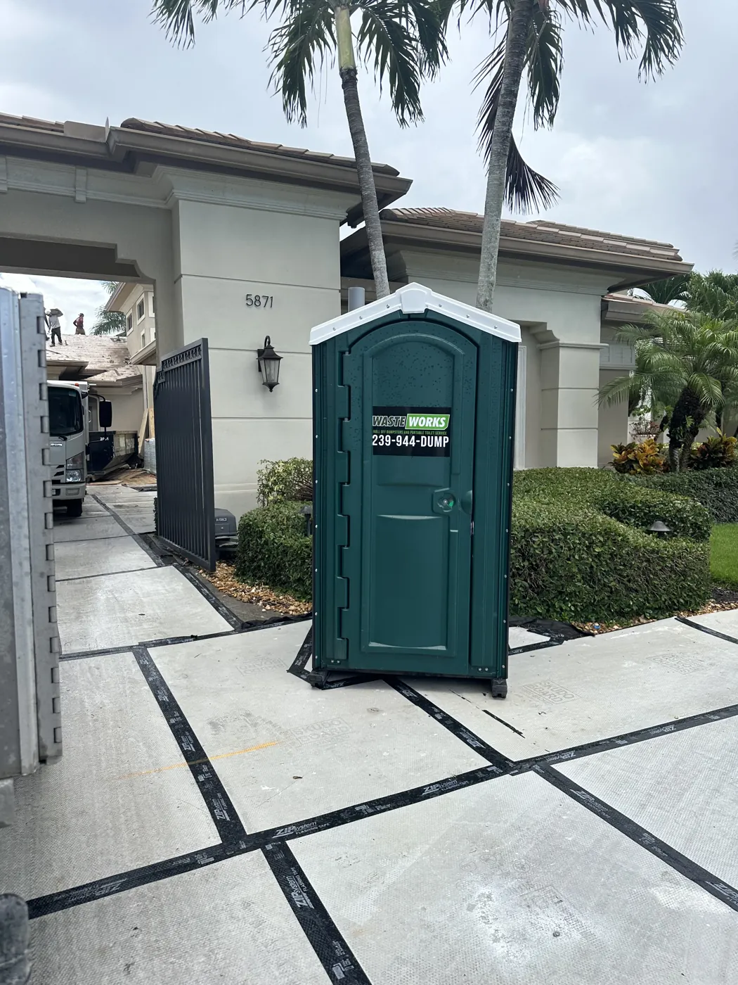 A Waste Works portable toilet at a residential renovation site